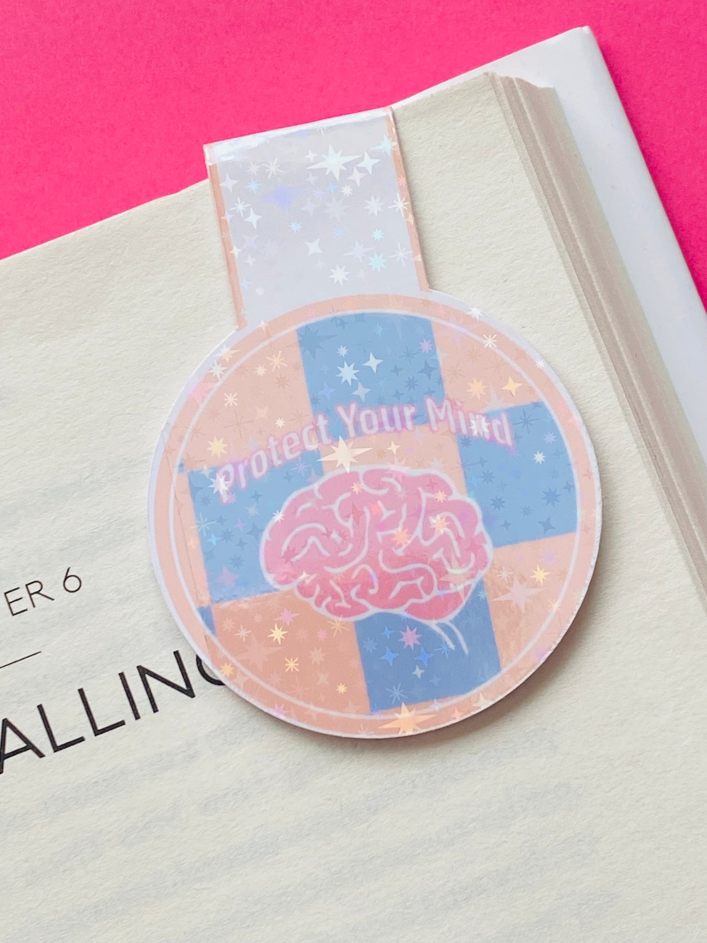Glossy white Cardstock magnetic bookmark with the image of a brain on a blue and orange checked background and text caption of “Protect Your Mind”