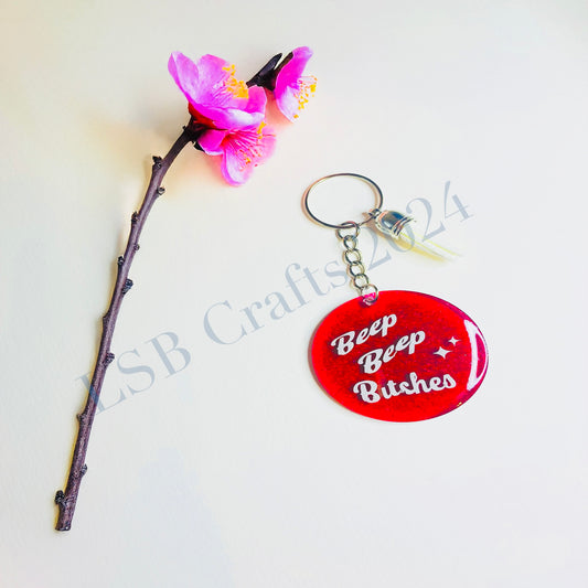 Plain Pink Background (glossy) with White Vinyl (glossy) and White Tassel.

Design details on the acrylic keychain is personalised with the text “Beep Beep Bitches”