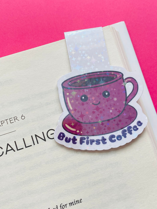 Glossy white Cardstock magnetic bookmark on a Pink Background with the image of a pink cup and saucer with the text caption “But First Coffee”