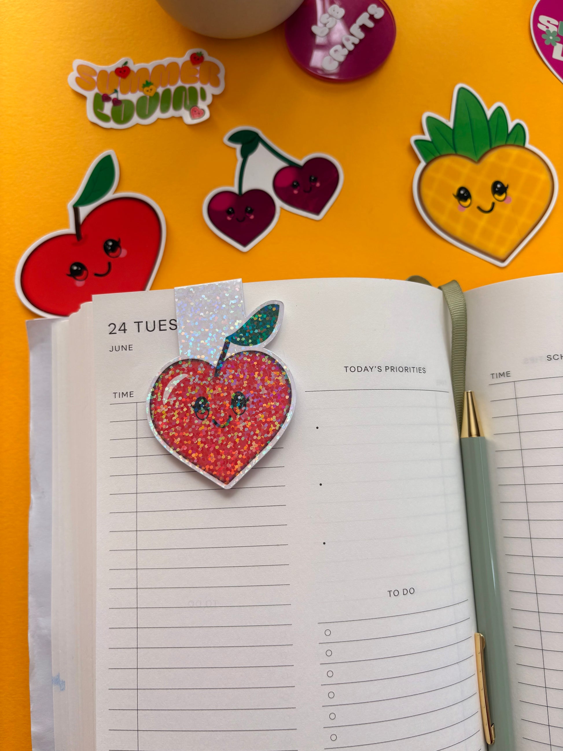 Glossy white cardstock magnetic bookmark with the image of a heart shaped kawaii apple.