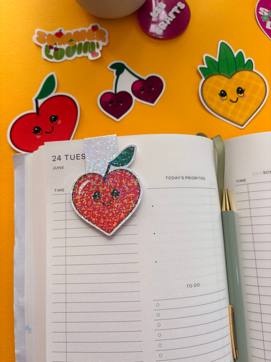 Glossy white cardstock magnetic bookmark with the image of a heart shaped kawaii apple.