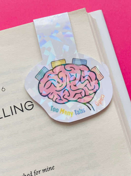 Glossy white Cardstock magnetic bookmark with the image of a brain and text caption of “Too Many Tabs Open”