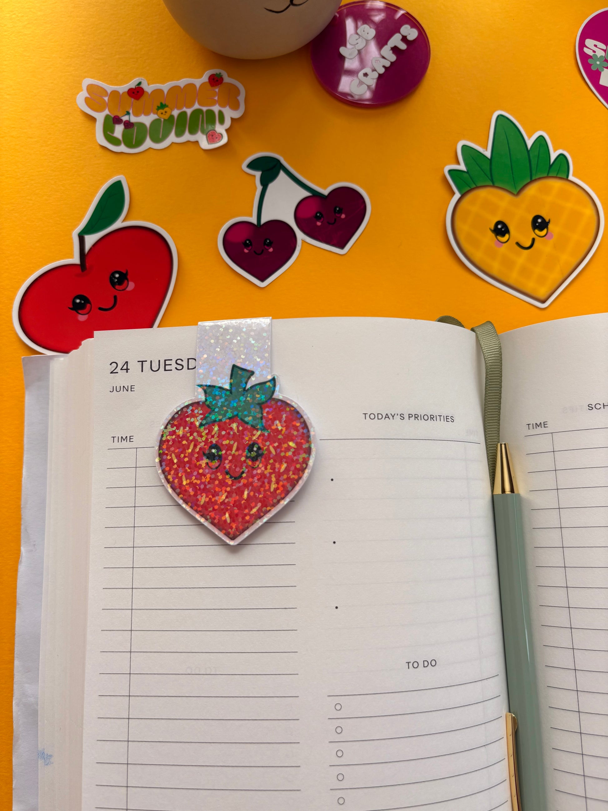 Glossy white cardstock magnetic bookmark with the image a heart shaped kawaii strawberry.